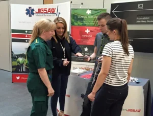 Paramedic and Jigsaw Medical team talking to student paramedics at exhibition