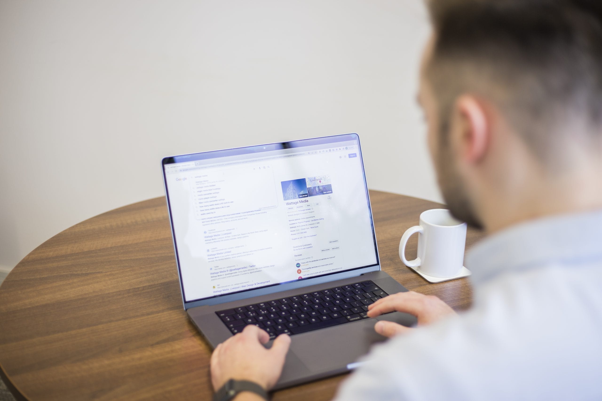 Wattage Media search results on laptop screen with Jack looking