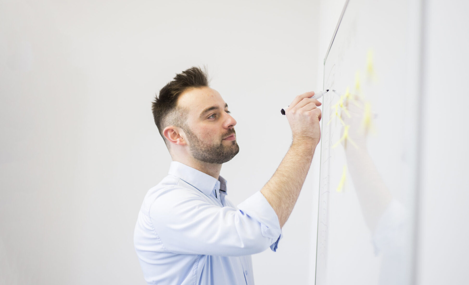 Drawing website design sitemap on whiteboard in client meeting at Wattage Media in Liverpool
